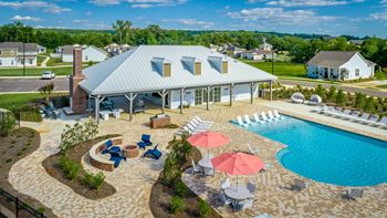 Aerial view of pool pavilion with entertainment, social lounge, and fire pit